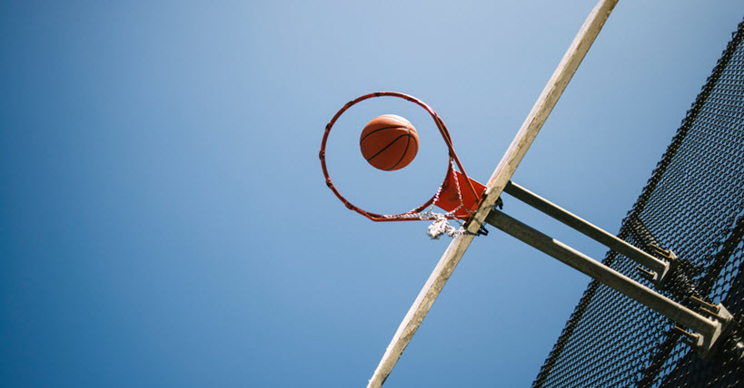 basketball in midair going through a basketball net