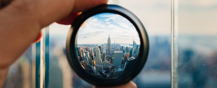 Close-up of a city view through a magnifying glass.