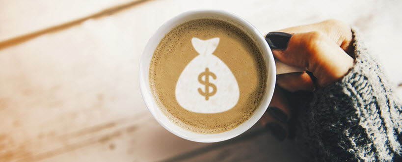 Bird’s eye view of latte art with a dollar sign pattern. 