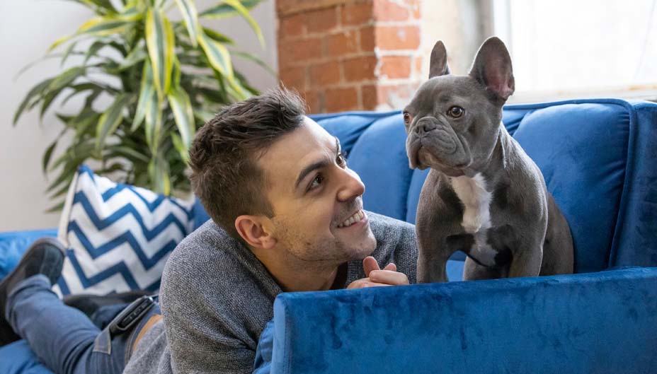 Frankie on the couch with his dog.