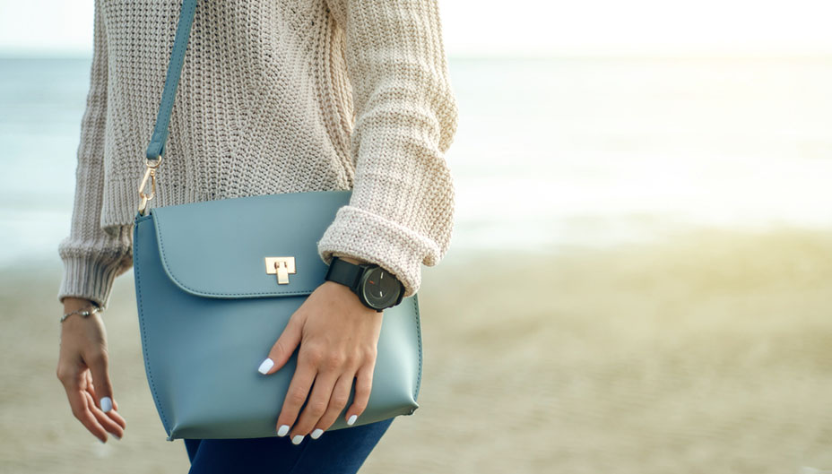 A woman holding a blue purse