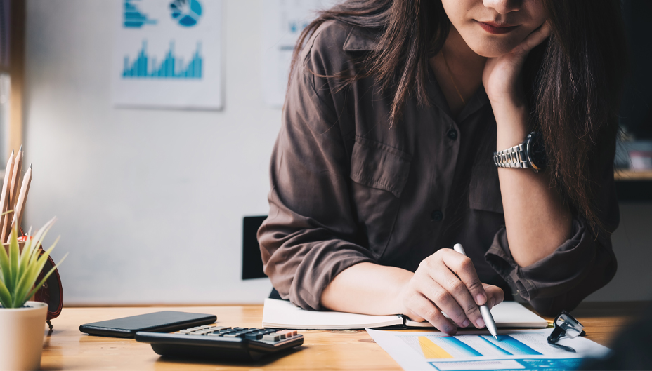 A woman looking over a printout of a chart.