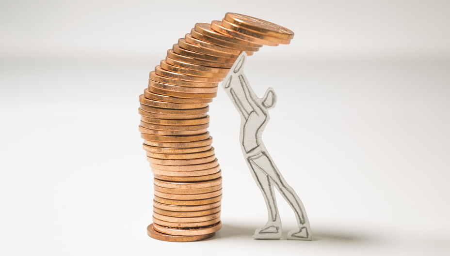 A stack of falling pennies is being held up by a cut-out drawing of a person. 