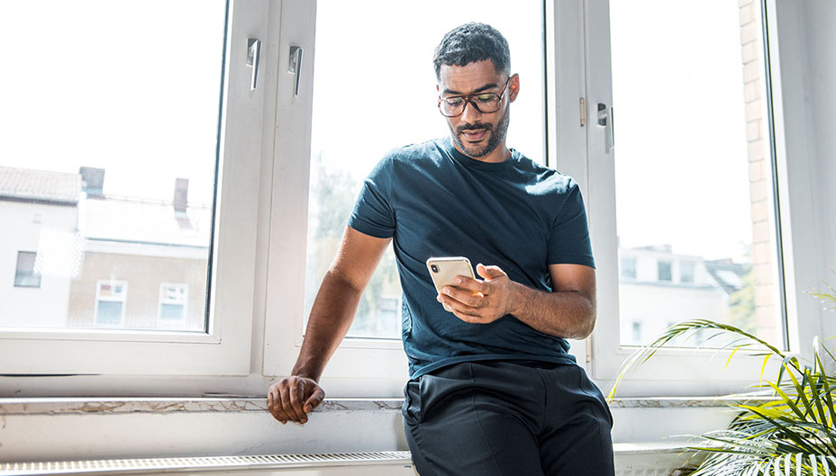 A man looks at his phone to check top traded stocks.