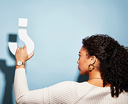 Woman holding question mark