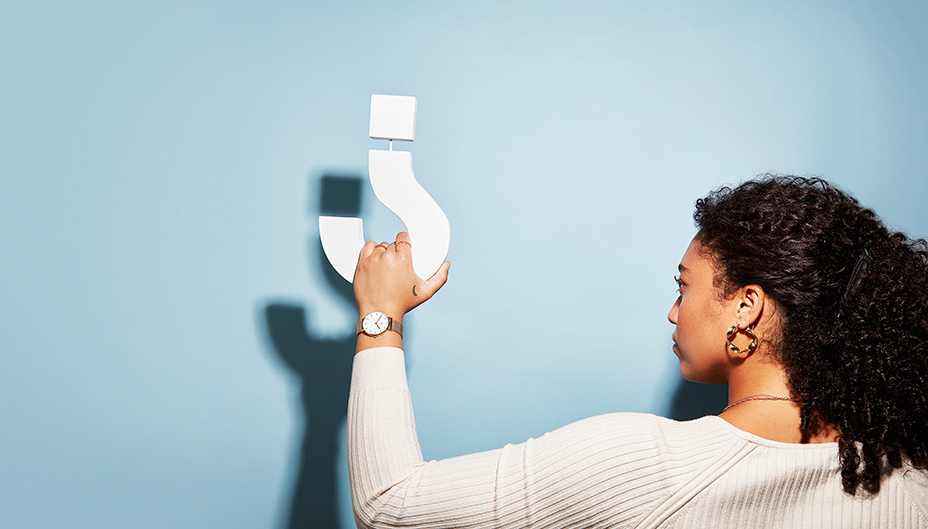 Woman holding question mark