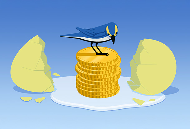 A broken eggshell with a stack of coins in the middle and a bird sitting on top of it
