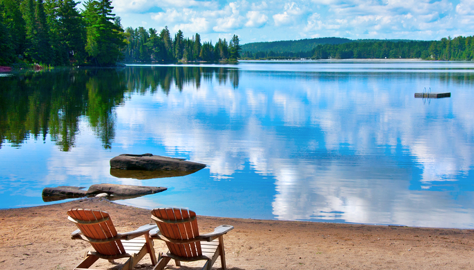 Deux chaises Muskoka au bord d’un lac