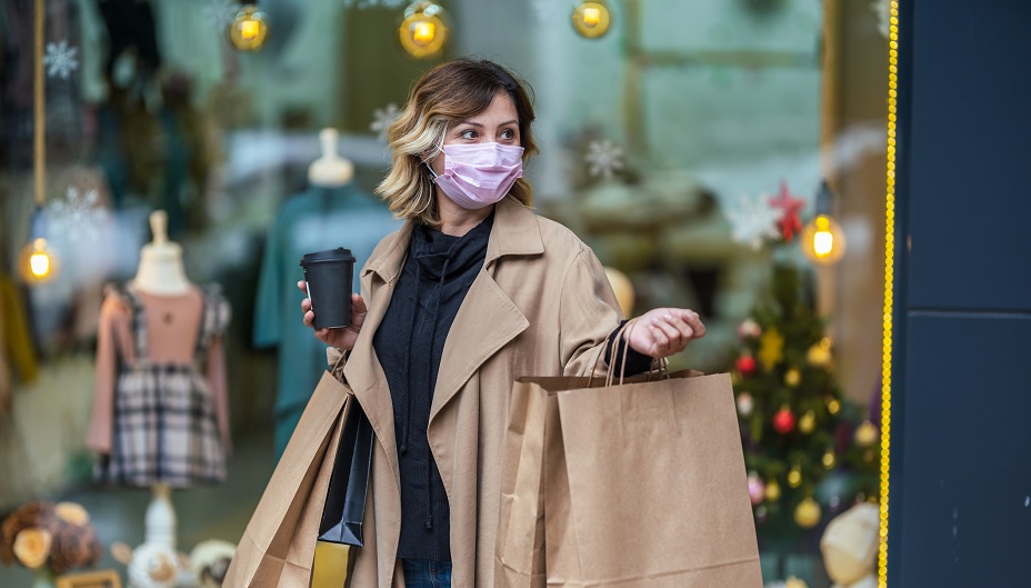 A person holding shopping bags. Canadian consumer spending remains strong ahead of the holidays.