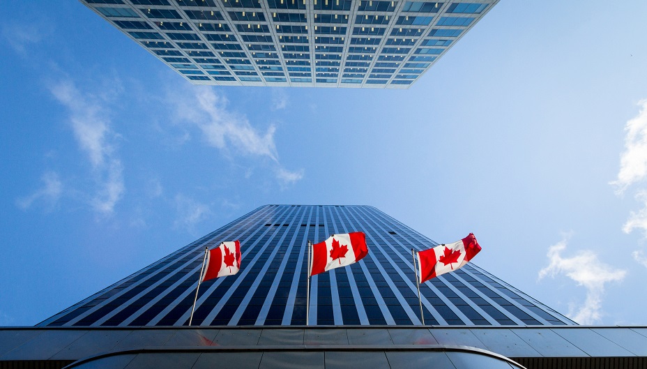 Skyscrapers with three Canadian flags.