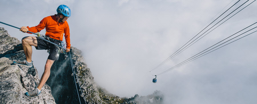 Mountaineer abseiling off the edge of Table Mountain