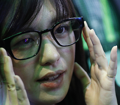 Woman trying on the Focals Smart Glasses.